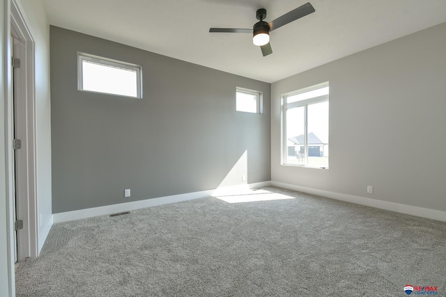 spare room with light colored carpet and ceiling fan