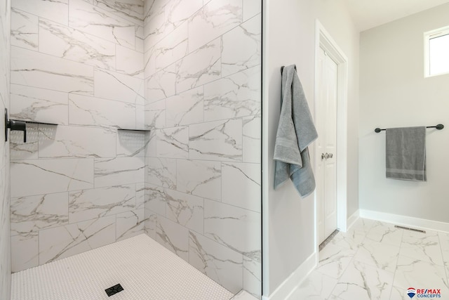 bathroom with tiled shower