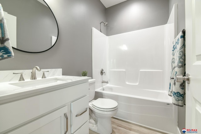 full bathroom with toilet, vanity, shower / bathtub combination, and hardwood / wood-style flooring