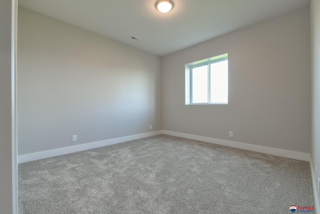 spare room with light colored carpet