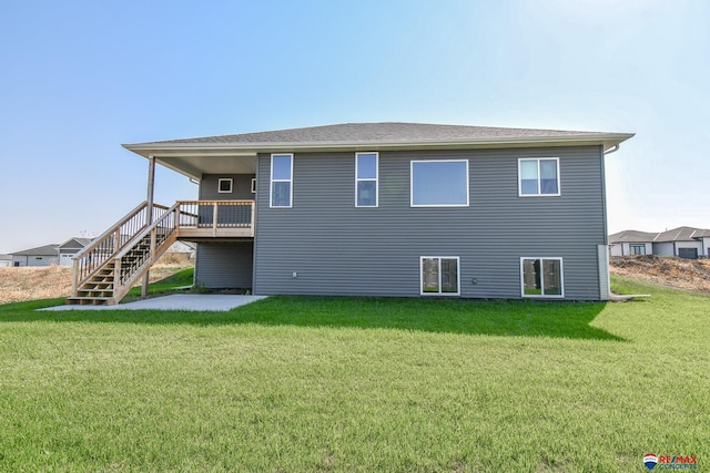 rear view of house featuring a yard and a deck