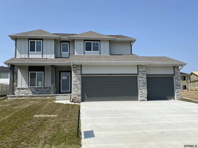 prairie-style house featuring a garage and a front lawn