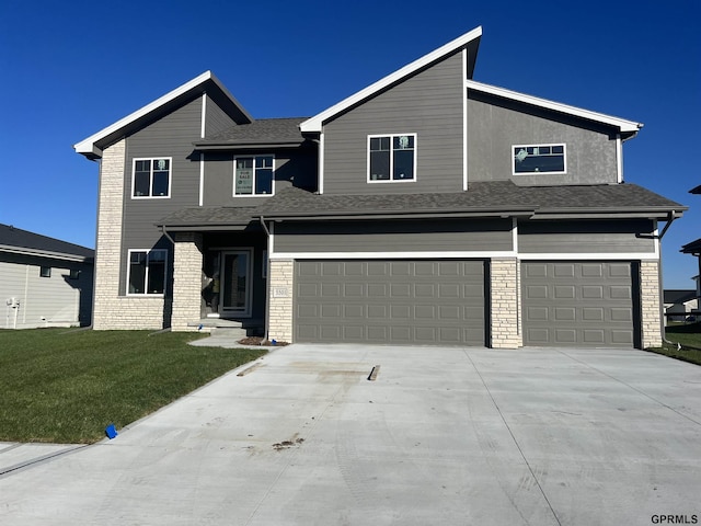 view of front of property with a garage and a front lawn