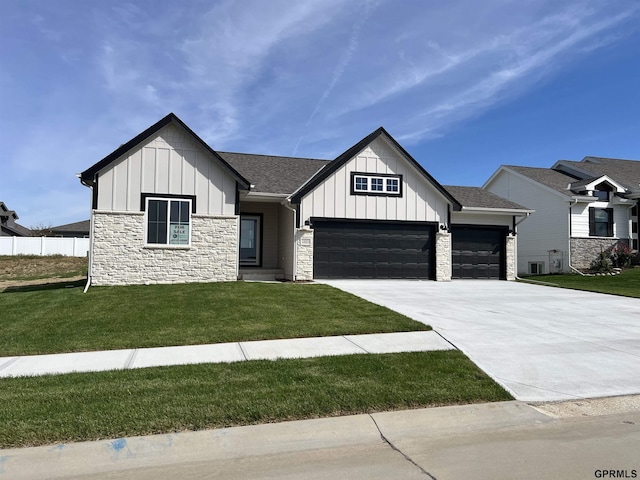 modern farmhouse style home featuring a front lawn and a garage