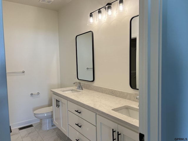 bathroom with toilet and vanity