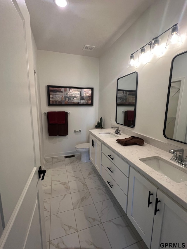 bathroom featuring toilet and vanity