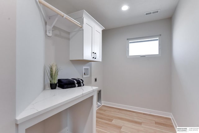 laundry room featuring washer hookup, light wood-type flooring, cabinets, and hookup for an electric dryer