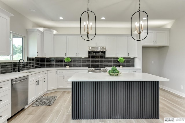 kitchen featuring white cabinetry, stainless steel appliances, and a kitchen island