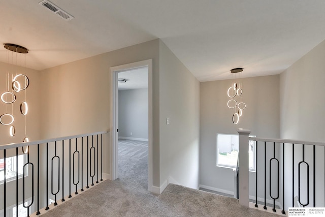 corridor featuring light colored carpet