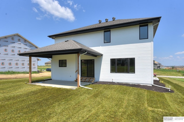 back of house with a patio and a lawn