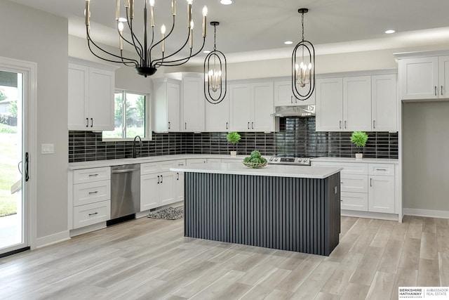 kitchen featuring white cabinetry, tasteful backsplash, appliances with stainless steel finishes, a kitchen island, and pendant lighting