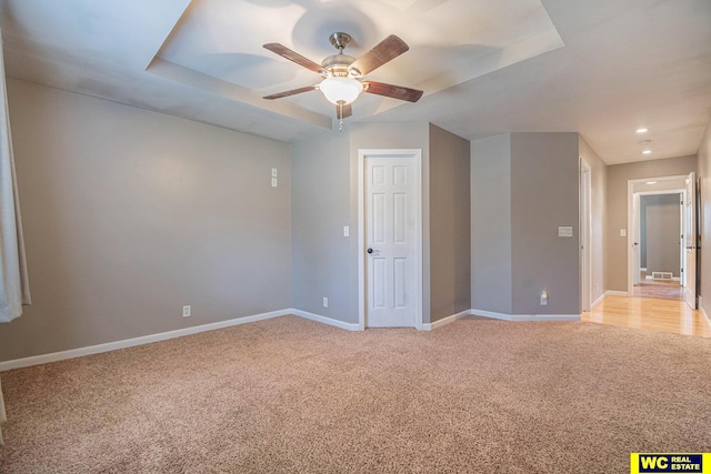 unfurnished room with light colored carpet and ceiling fan