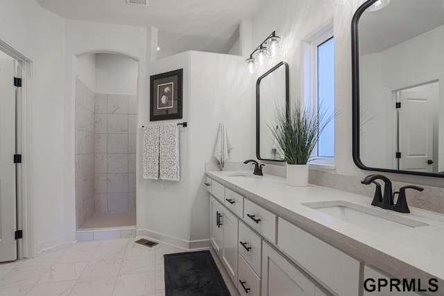 bathroom featuring vanity and a tile shower