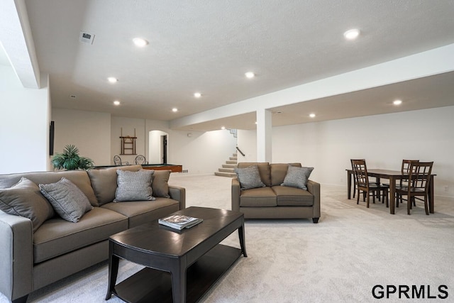 living room with light colored carpet and a textured ceiling