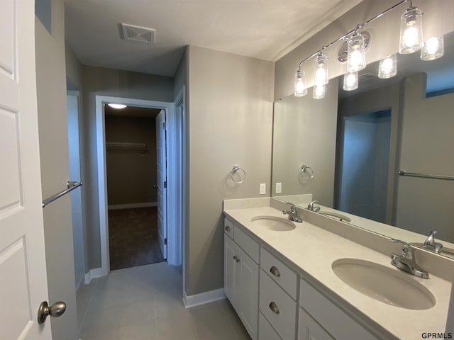 bathroom featuring tile patterned flooring and vanity