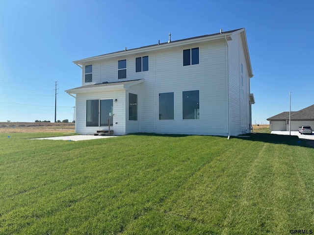 back of property with a lawn and a patio