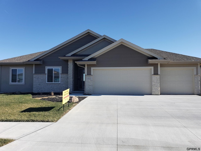 view of front of home with a garage and a front lawn