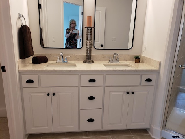 bathroom with tile patterned floors, vanity, and an enclosed shower