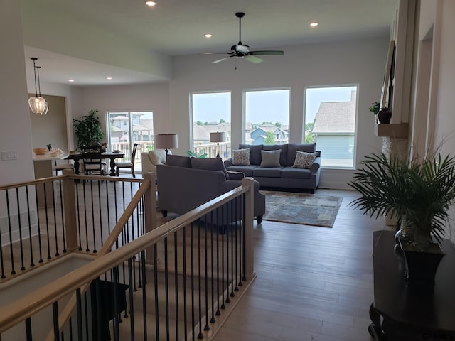 living room with wood-type flooring and ceiling fan