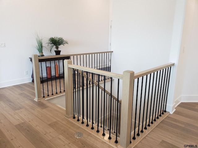 stairs featuring hardwood / wood-style flooring