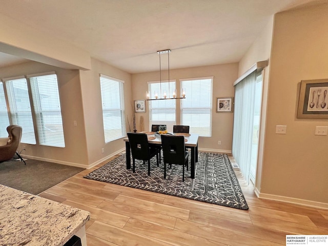 dining area featuring an inviting chandelier