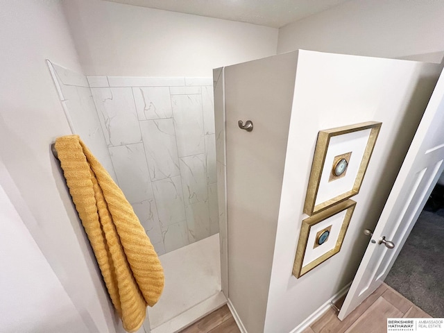 bathroom with hardwood / wood-style floors and walk in shower