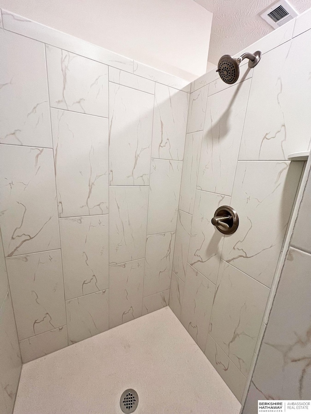 bathroom with a tile shower