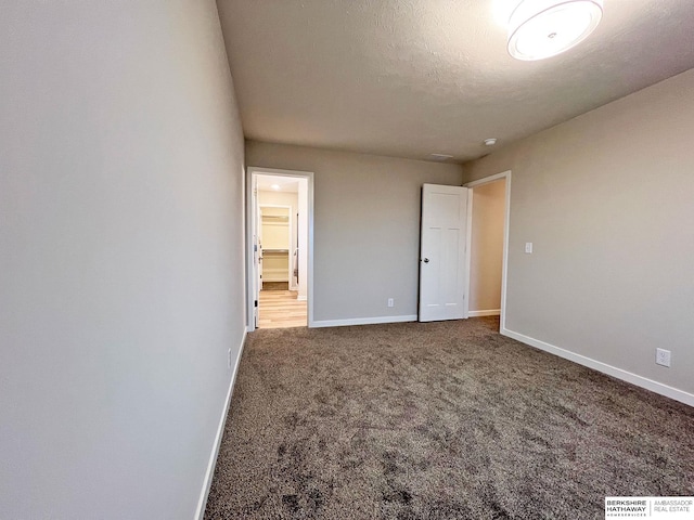 unfurnished bedroom featuring carpet flooring and a textured ceiling