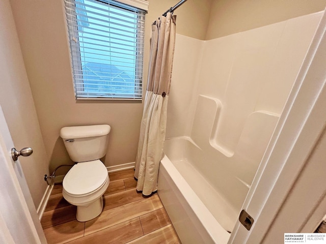 bathroom featuring shower / bath combo and toilet