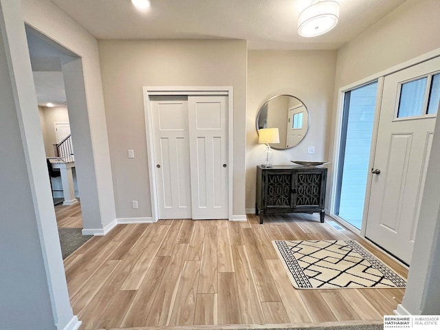 foyer entrance with light hardwood / wood-style flooring