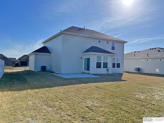 back of house with cooling unit, a patio area, and a lawn