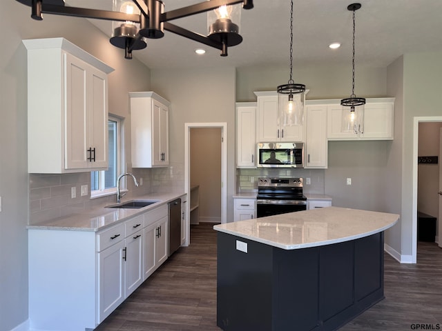 kitchen featuring white cabinetry, a center island, stainless steel appliances, and sink