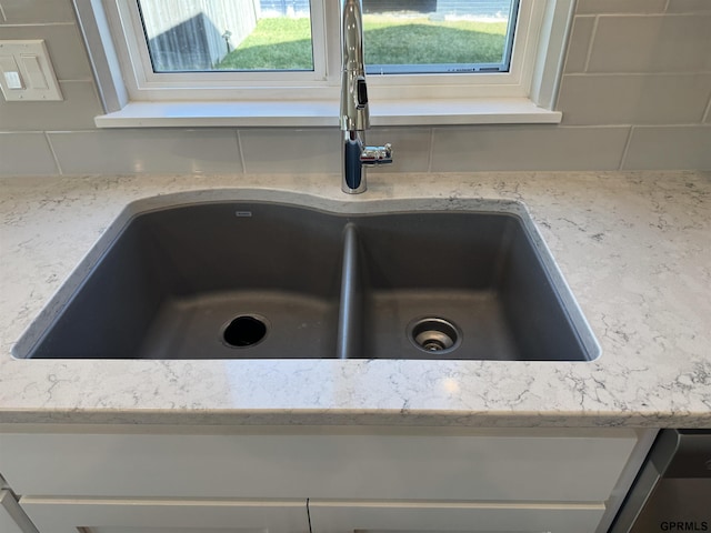 details with light stone countertops, tasteful backsplash, and sink