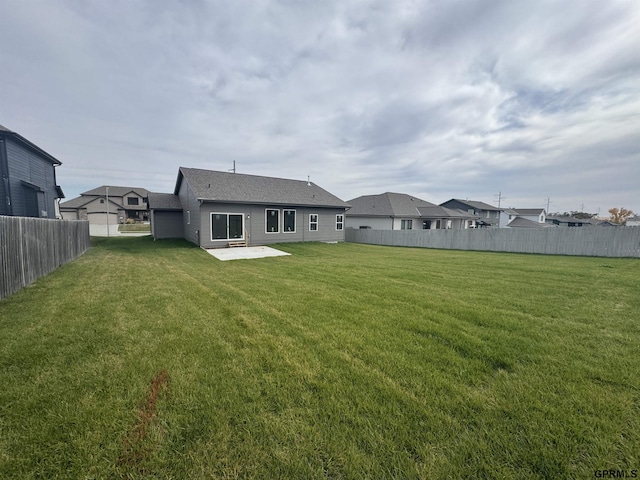 back of house with a patio area and a lawn