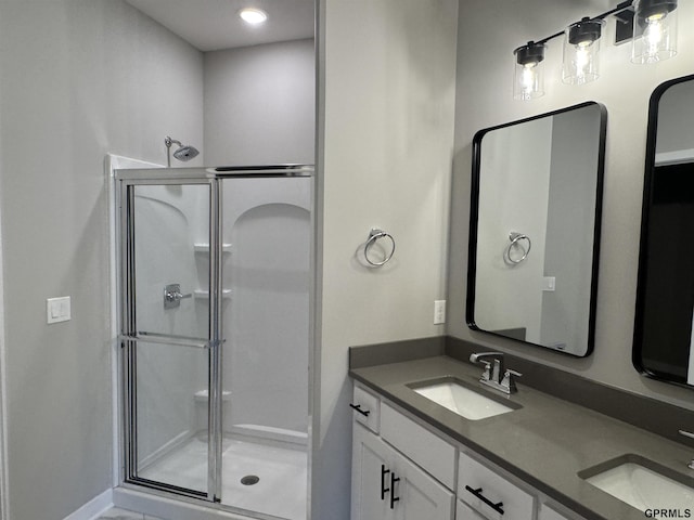 bathroom with vanity and a shower with shower door