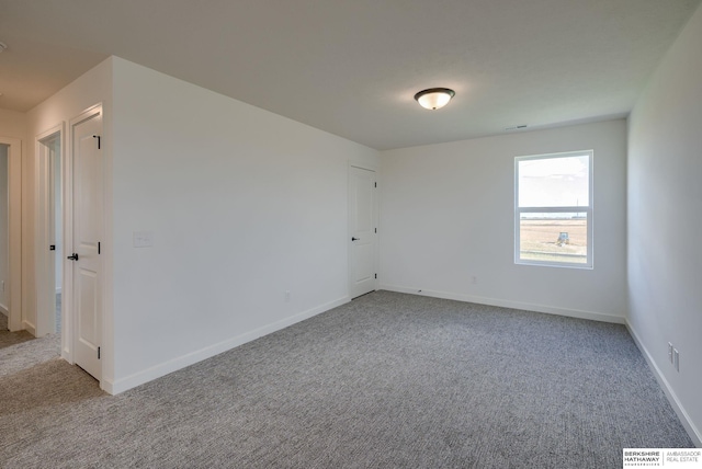 spare room with light colored carpet