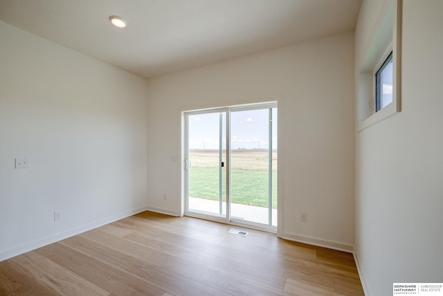 empty room with light hardwood / wood-style floors