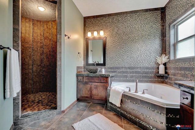 bathroom featuring tile patterned floors, vanity, and plus walk in shower