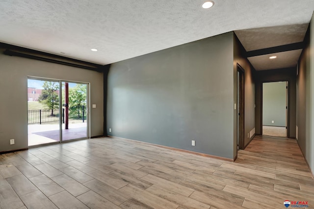 empty room with a textured ceiling