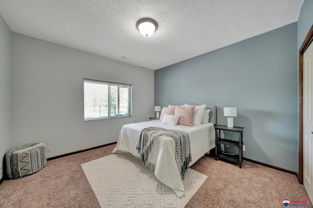 carpeted bedroom featuring a textured ceiling