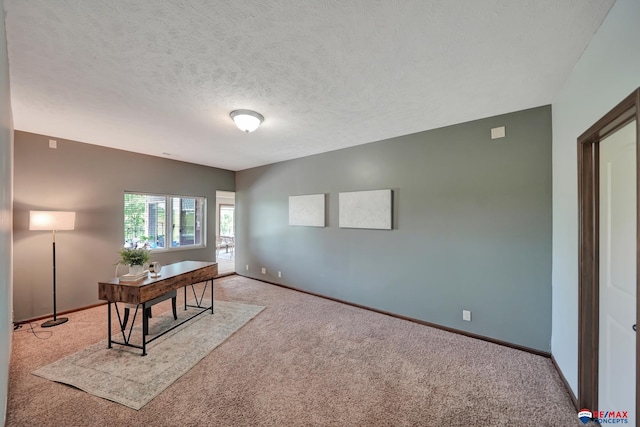 home office with carpet floors and a textured ceiling