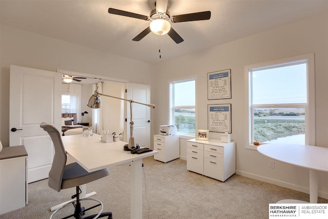 office space featuring ceiling fan and light colored carpet