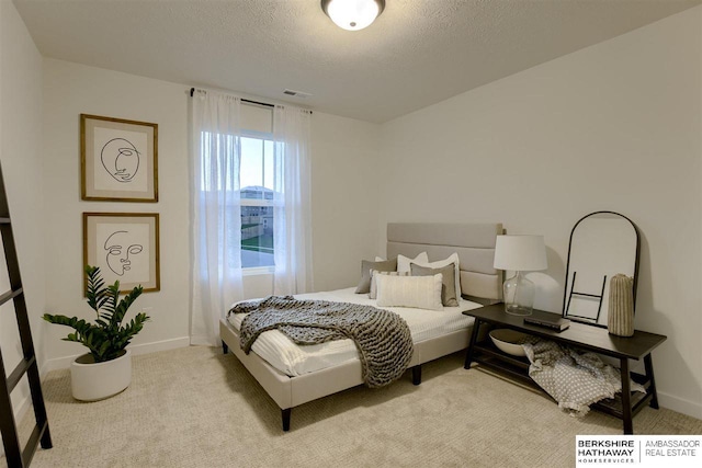 carpeted bedroom featuring a textured ceiling