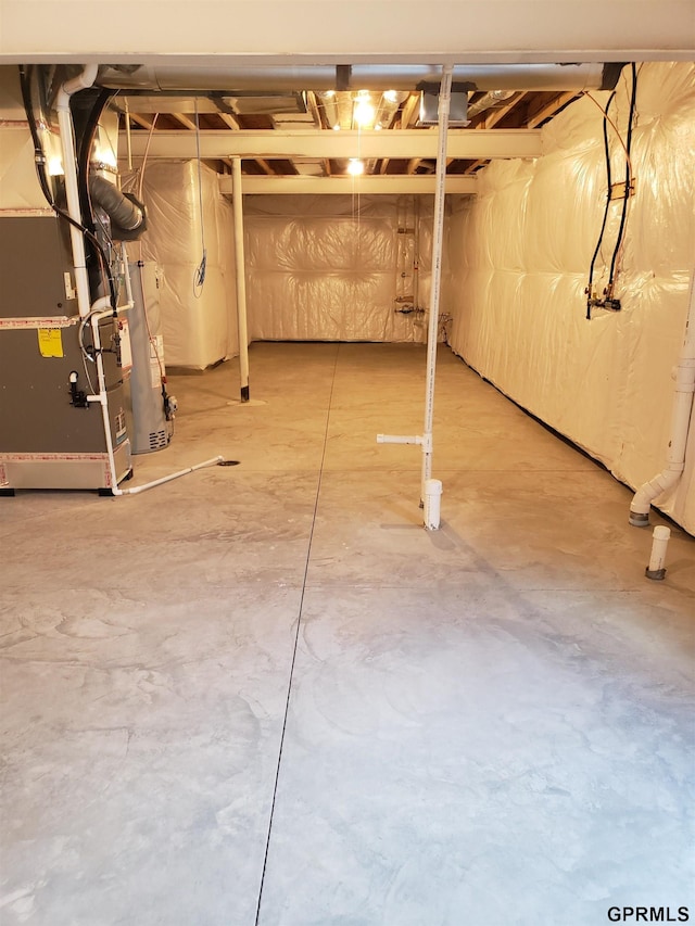 basement with water heater and heating unit