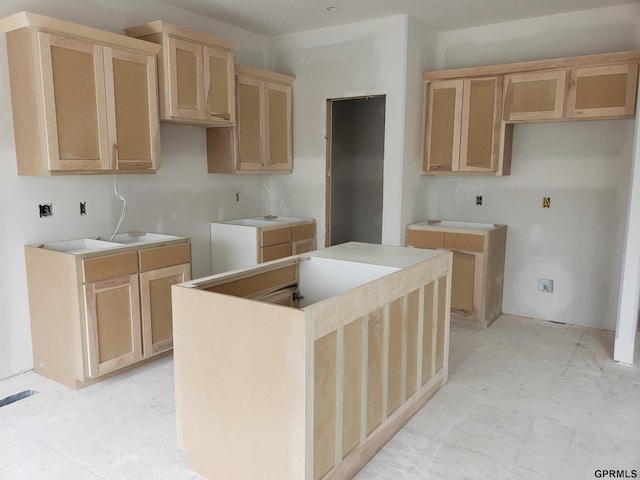 kitchen with a center island and light brown cabinets