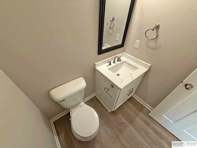 bathroom with vanity, wood-type flooring, and toilet