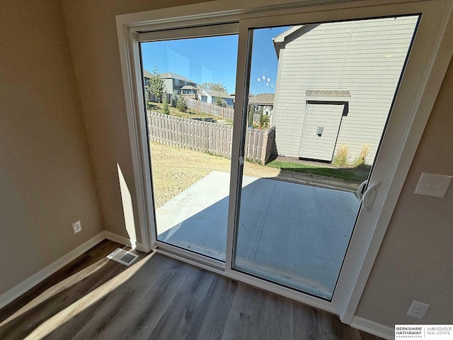 doorway with dark wood-type flooring