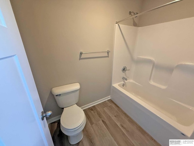 bathroom with toilet, tub / shower combination, and hardwood / wood-style flooring