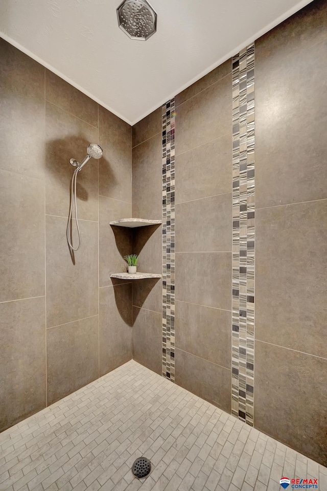 bathroom with a tile shower