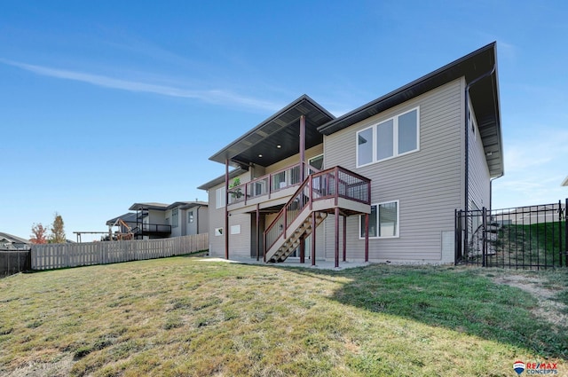 back of house with a yard and a deck